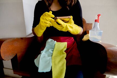 Happy housewives in rubber gloves with dust-wiping equipment, aerosol cleaners ready cleaning. concept do housework.の写真素材