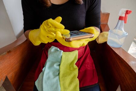 Happy housewives in rubber gloves with dust-wiping equipment, aerosol cleaners ready cleaning. concept do housework.の写真素材