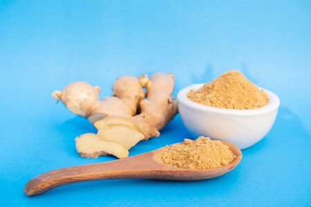 Ginger fresh and ginger powder on blue background. concept healthy spice diet.の写真素材