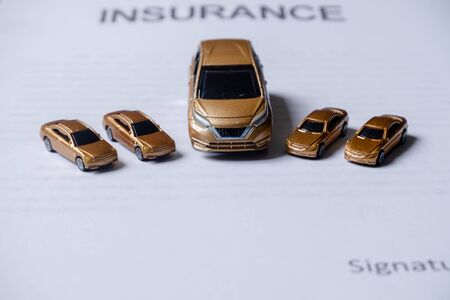 Car placed on insurance documents. Car insurance concept.