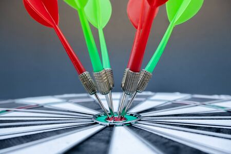 The arrow in the middle of the dartboard Demonstrate the concept of a successful business goal.