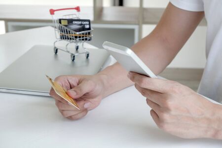 Young man people who hold credit cards and smartphones for online shopping and making payments...
