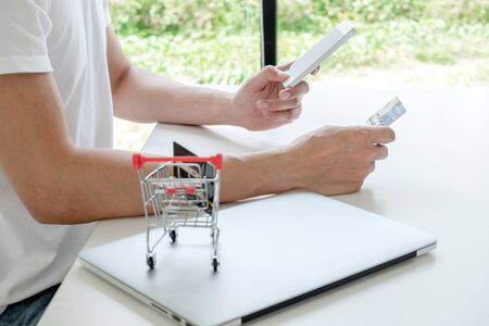 Young man people who hold credit cards and smartphones for online shopping and making payments...