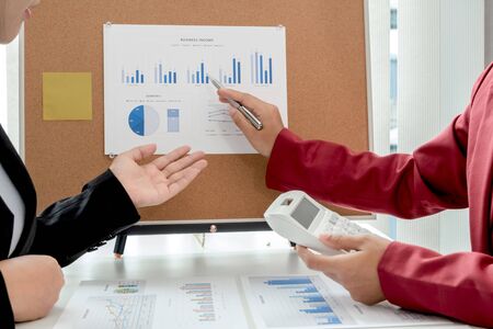 Two business leader discussing the charts and graphs showing the results, Planning to start new...
