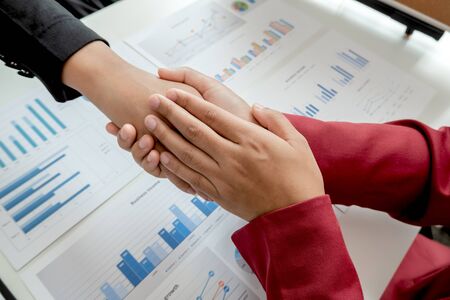 Shaking hand, Two business leader discussing the charts and graphs showing the results, Planning to start new strategy for big success.の写真素材