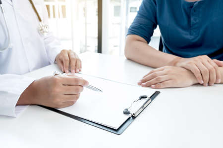 Female doctors who treat patients make an appointment to listen to the results after a physical examination and explain medical information and diagnose the disease. Medical concepts and good health.の写真素材