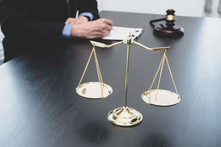 Professional male lawyers work at a law office There are scales, Scales of justice, judges gavel, and litigation documents. Concepts of law and justice.の写真素材