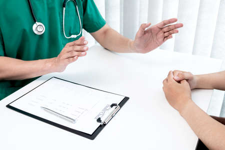 Male doctors explain and recommend treatment after a male patient meets a doctor and receives results regarding illness problems. Medical and health care concepts.の写真素材