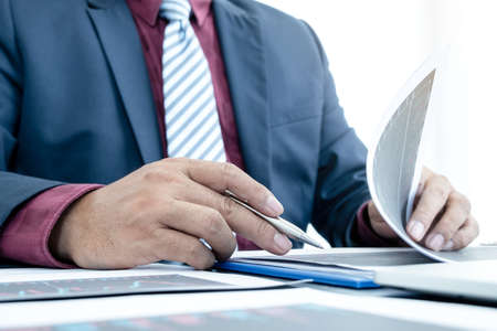 Hand of businessmen are planning business investments related to shares By analyzing and calculating the stock market for marketing profits.の写真素材