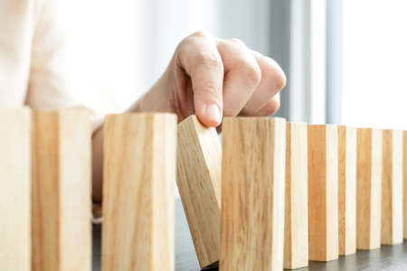 Hands of businesswomen playing wooden block game. Concept Risk of management and strategy plans for business growth and success.の写真素材