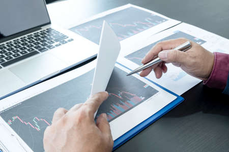 Hand of businessmen are planning business investments related to shares By analyzing and calculating...