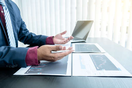 Hand of businessmen are planning business investments related to shares By analyzing and calculating...
