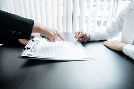 Real estate agents have a rental contract form for customers to sign a contract by the formal rental agreement Rental and insurance concepts.の写真素材