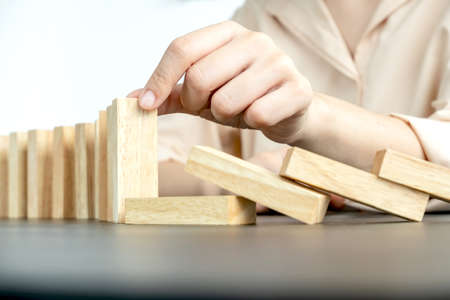 Hands of businesswomen playing wooden block game. Concept Risk of management and strategy plans for business growth and success.の写真素材