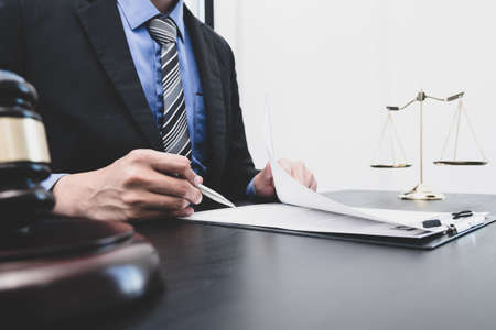 Professional male lawyers work at a law office There are scales, Scales of justice, judges gavel, and litigation documents. Concepts of law and justice.の写真素材