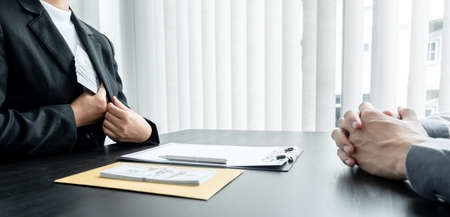 Businessmen make an agreement with the money proposed by his partner to bribe in the company. The concept of corruption.の写真素材