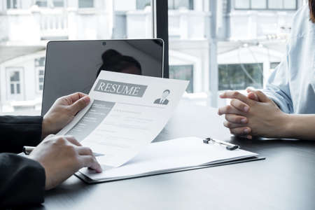 Business people hold a resume and talk to job applicants for job interviews about careers and Her personal history in the company. Recruitment concepts.の写真素材