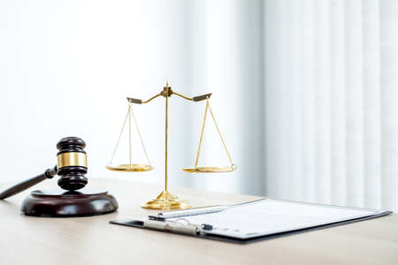 The judge's gavel at the law firm has scales, scales of justice, and litigation documents. Concepts of law and justice.の写真素材