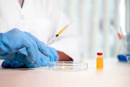 Professional doctors perform testing and analyzing samples of vaccines for immunization prevention...