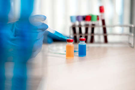 Professional doctors perform testing and analyzing samples of vaccines for immunization prevention...