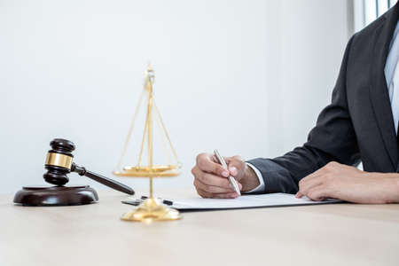 Professional male lawyers work at a law office There are scales, Scales of justice, judges gavel, and litigation documents. Concepts of law and justice.の写真素材