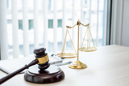 The judge's gavel at the law firm has scales, scales of justice, and litigation documents. Concepts...