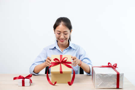 Asian women happy to open surprise box are stunned with excitement, joy and smile on holidays,...