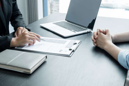 Business people hold a resume and talk to job applicants for job interviews about careers and Her...