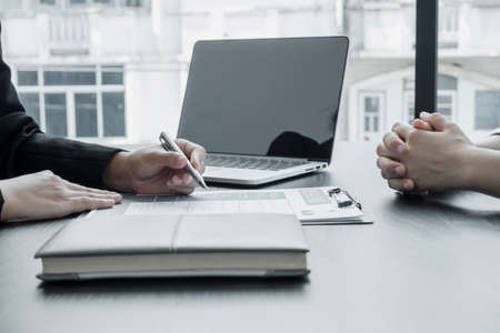 Business people hold a resume and talk to job applicants for job interviews about careers and Her personal history in the company. Recruitment concepts.の写真素材