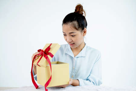 Asian women happy to open surprise boxes are stunned with excitement, joy, and smile on holidays,...