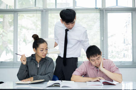 University students study hard and listen to teachers for their lessons with special lectures in the columns of math class.の写真素材