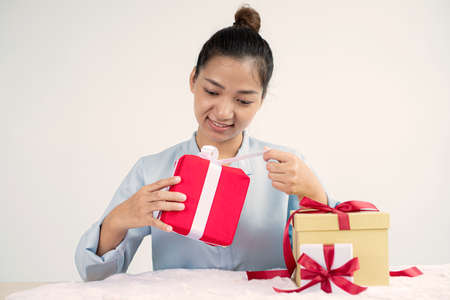 Asian women happy to open surprise boxes are stunned with excitement, joy, and smile on holidays,...
