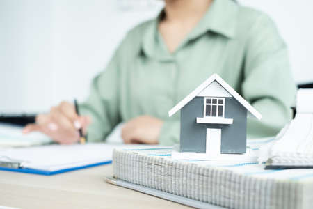 The designer is planning the interior of the house, illustrating and choosing the perfect colors for the new home with sample materials on the desk. Real estate design business Ideas.の写真素材