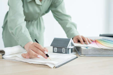 The designer is planning the interior of the house, illustrating and choosing the perfect colors for...