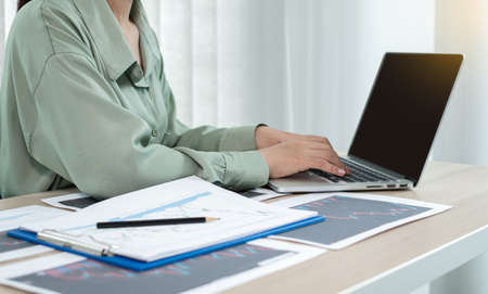 Hand of businesswoman are planning business investments related to shares By analyzing and...