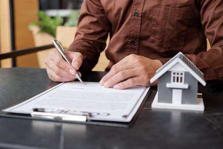 Agents working in real estate investment and lease contracts, contract home insurance home purchase, and purchase approval for clients.の写真素材