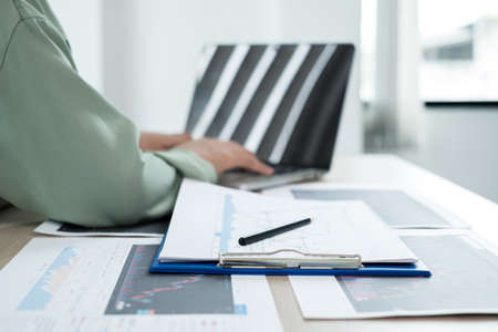 Hand of businesswoman are planning business investments related to shares By analyzing and...