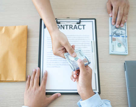 The owner's business offers and gives money to his partners for bribery and corruption. The concept of bribery and corruption.の写真素材