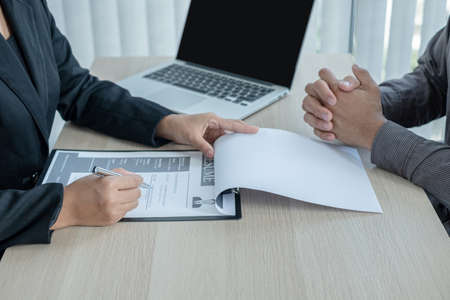 Business people hold a resume and talk to job applicants for job interviews about careers and Her personal history in the company. Recruitment concepts.の写真素材