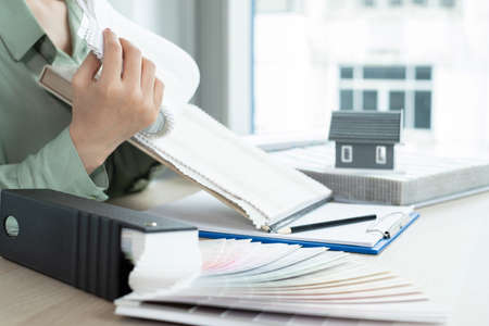 The designer is planning the interior of the house, illustrating and choosing the perfect colors for...