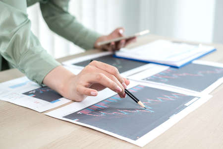 Hand of businesswoman are planning business investments related to shares By analyzing and calculating the stock market for marketing profits.の写真素材