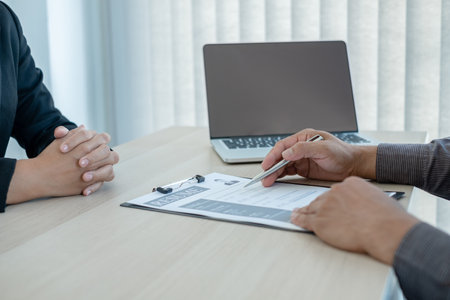 Business people hold a resume and talk to job applicants for job interviews about careers and Her...