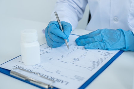 A male doctor is writing a prescription after a patient sees a doctor and receives the consequences of a hospital illness. Medical concepts and interests.の写真素材