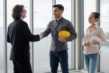 Shake hand Team of male and female engineers and architects, working team, meeting, discussing...
