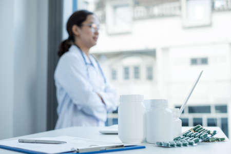 Medicine tablets, female doctor In uniform Asians stand at the hospital.の写真素材