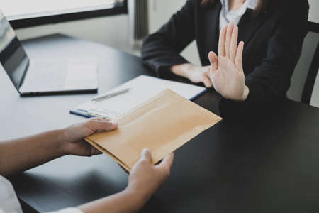 The businessman denies the money in envelope proposed by his partner to bribe the concept of bribery and corruption.の写真素材