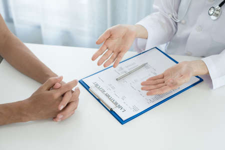 Female doctors explain and recommend treatment after a Male patient meets a doctor and receives...
