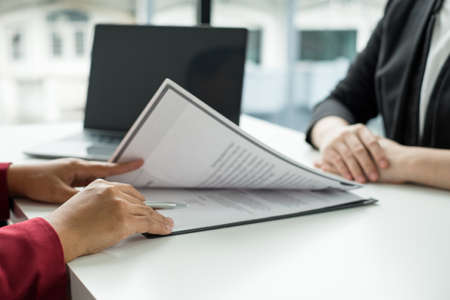 Business people hold a resume and talk to job applicants for job interviews about careers and Their...