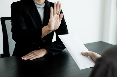 Corruption. The businessman denies the money proposed by his partner to bribe the concept of bribery and corruption.の写真素材