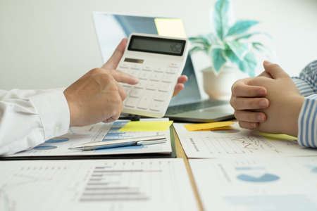 Two business leaders talk about charts, financial graphs showing results are analyzing and calculating planning strategies, business success building processes.の写真素材